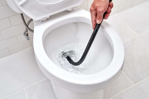 How do I unclog a toilet using a plunger or other household tools?