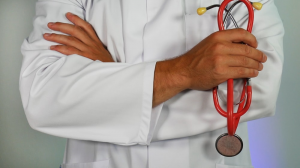 A doctor is holding a stethoscope 